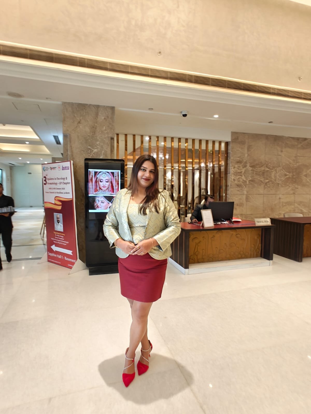 Neelam Roy in executive chic gold jacket and maroon skirt at hotel lobby
