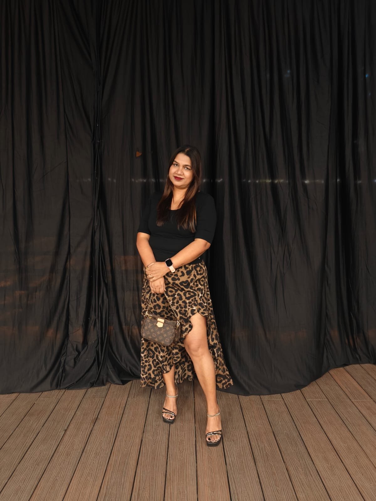 Neelam Roy in street style luxe — leopard print skirt with designer handbag