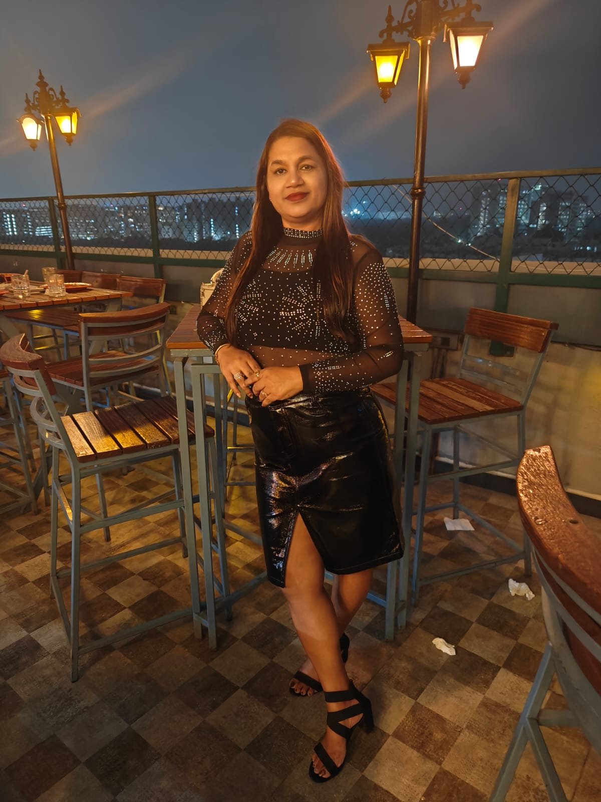 Neelam Roy at rooftop soirée with city skyline night view